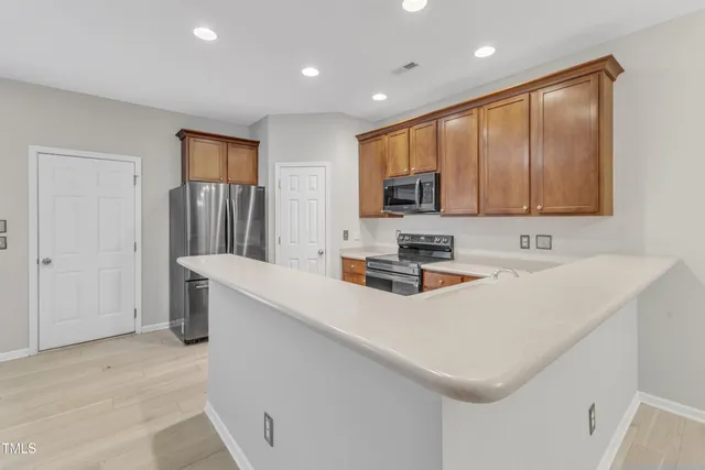 a kitchen with stainless steel appliances a refrigerator stove and microwave