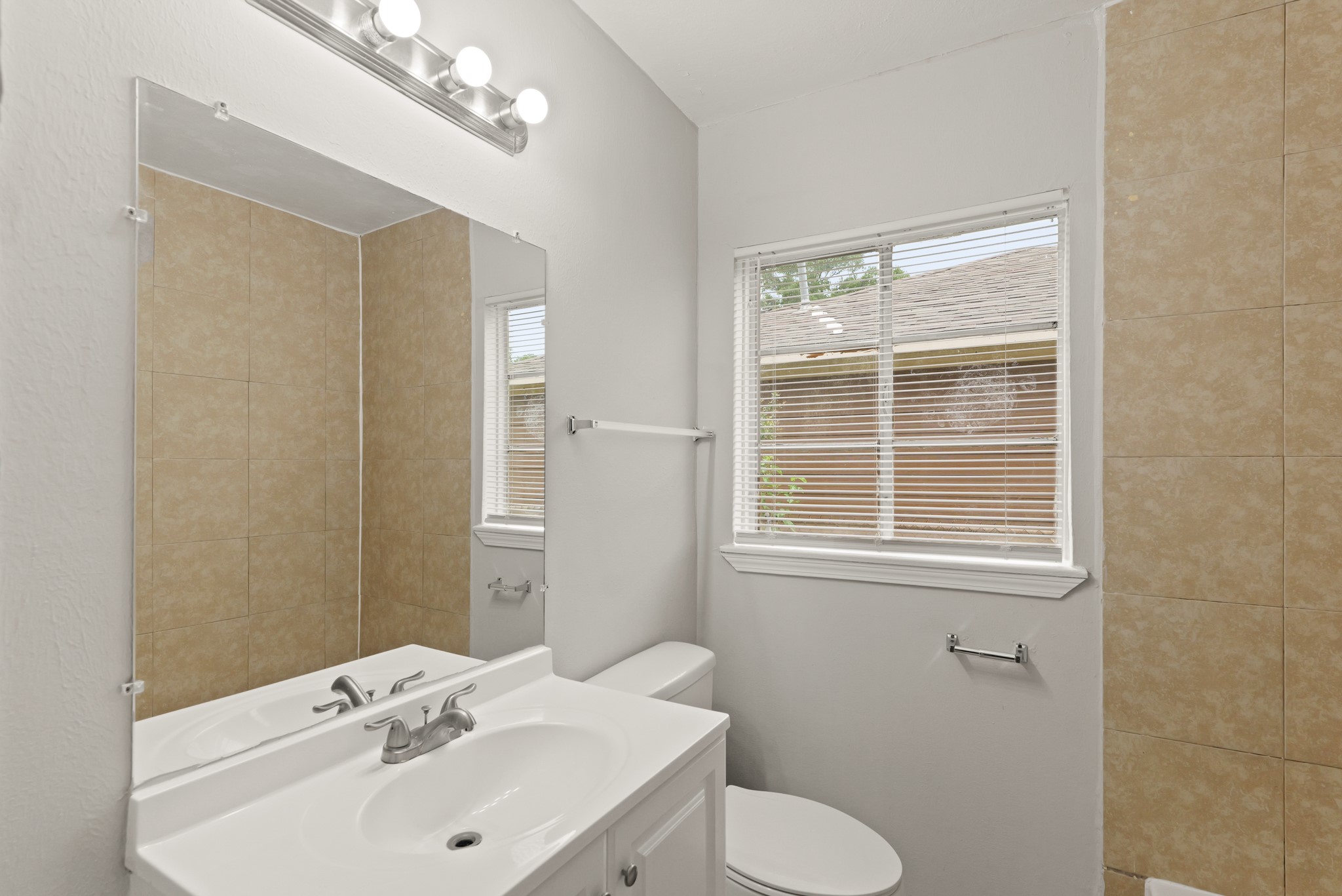 9133 Woodlyn Road Houston, TX 77078 - Photo 11 of 16 a bathroom with a sink and a mirror