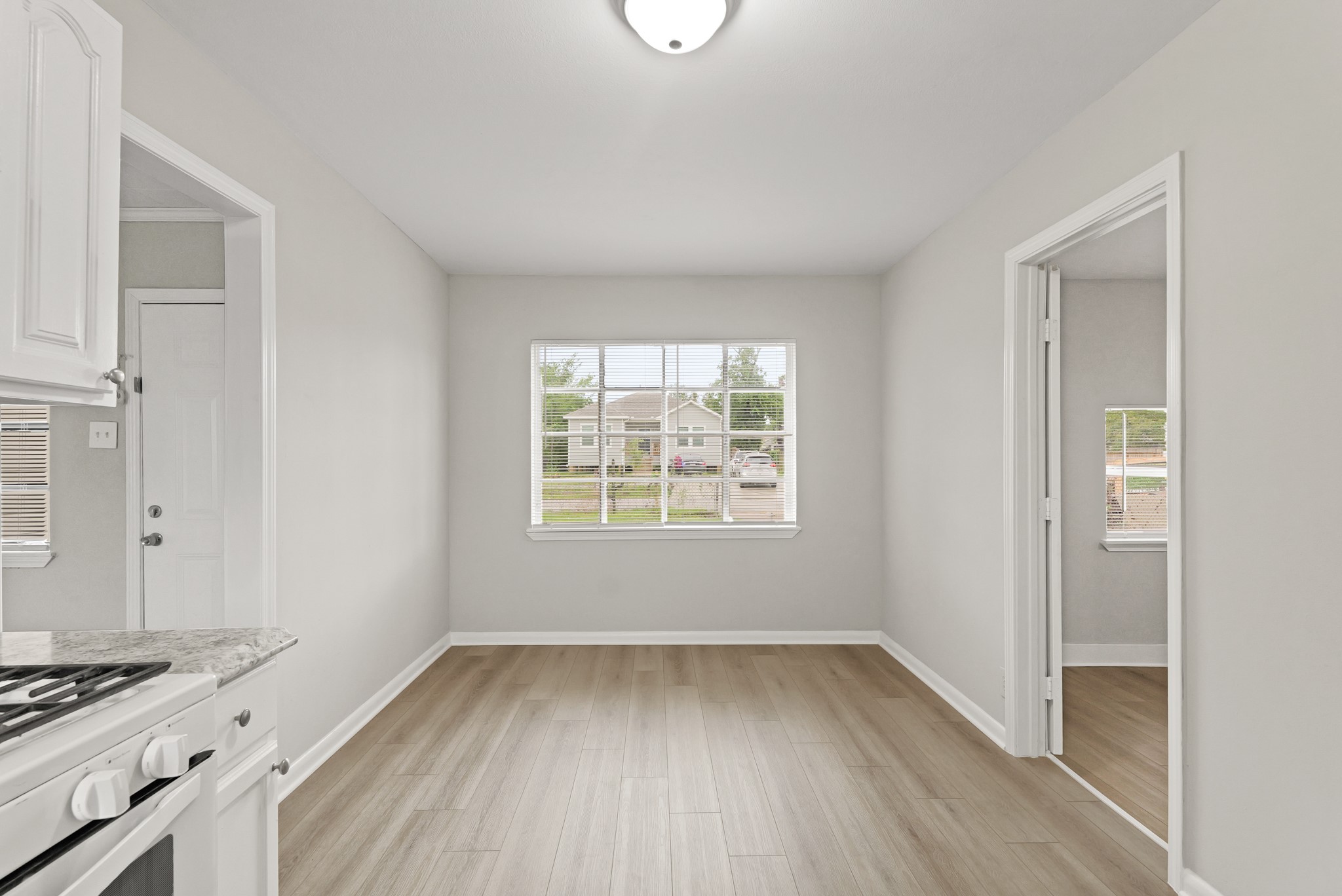 9133 Woodlyn Road Houston, TX 77078 - Photo 6 of 16 a view of a room with wooden floor and white walls
