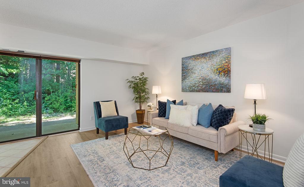 11600 Stoneview Square, Unit 60/2B Reston, VA 20191 - Photo 2 of 27 a living room with furniture a table and a large window