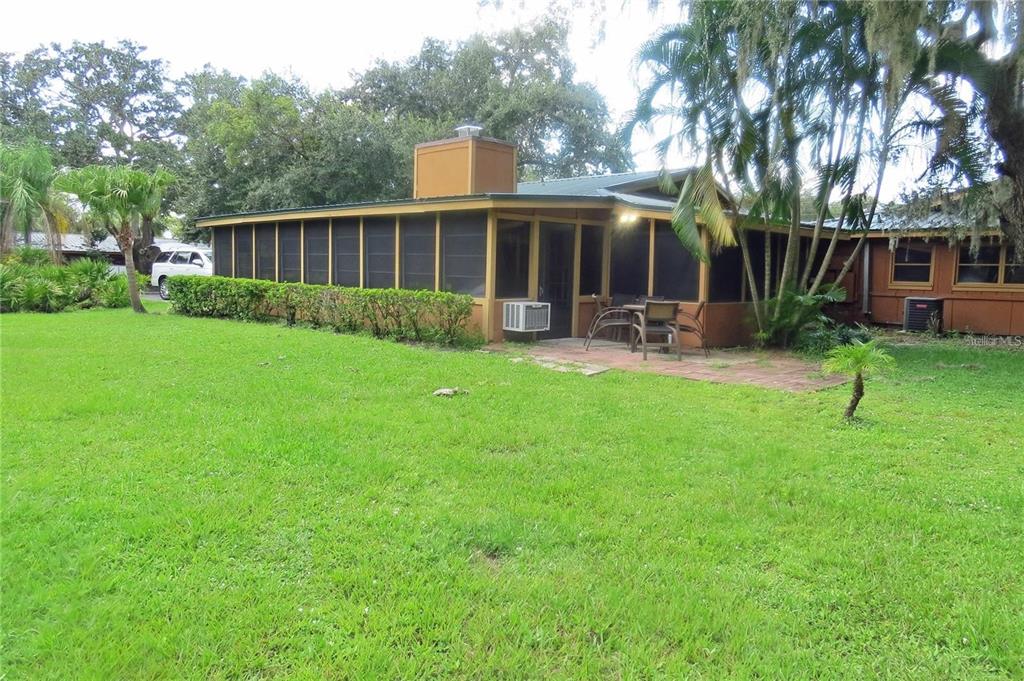 454 Cottage Circle, Unit 454 River Ranch, FL 33867 - Photo 26 of 27 a view of a house with backyard and sitting area