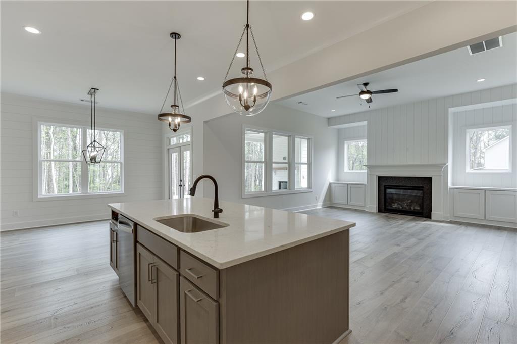 5410 Settingdown Road Cumming, GA 30041 - Photo 21 of 47 a kitchen with sink microwave and wooden floor