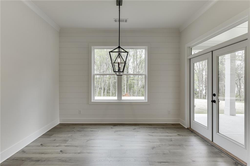 5410 Settingdown Road Cumming, GA 30041 - Photo 24 of 47 a view of an empty room with wooden floor and a window