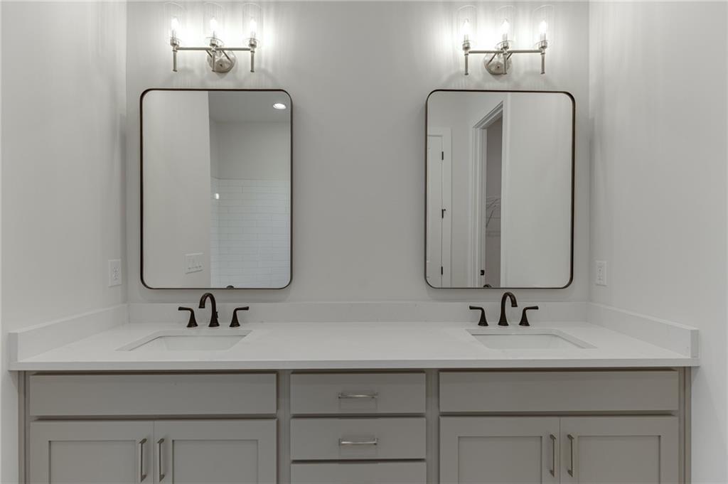 5410 Settingdown Road Cumming, GA 30041 - Photo 33 of 47 a bathroom with double vanity sinks and a mirror