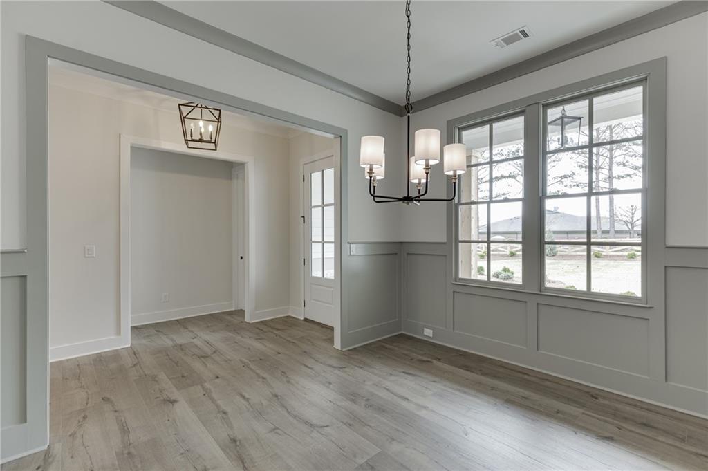 5410 Settingdown Road Cumming, GA 30041 - Photo 6 of 47 a view of empty room with wooden floor and fan