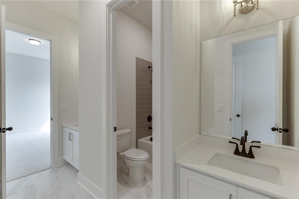 5410 Settingdown Road Cumming, GA 30041 - Photo 10 of 47 a bathroom with a sink a toilet and shower