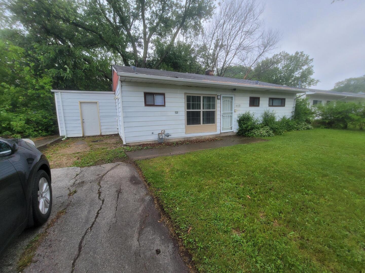 16523 Spaulding Avenue Markham, IL 60428 - Photo 2 of 15 a house view with a garden space
