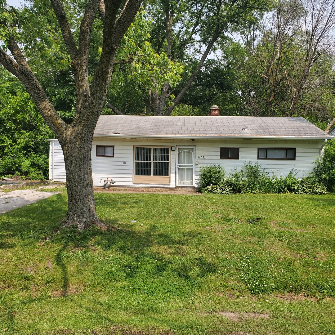 16523 Spaulding Avenue Markham, IL 60428 - Photo 5 of 15 a front view of house with yard and green space