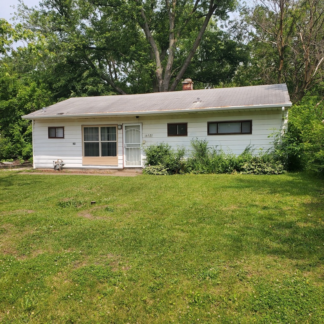16523 Spaulding Avenue Markham, IL 60428 - Photo 6 of 15 a front view of house with yard and green space