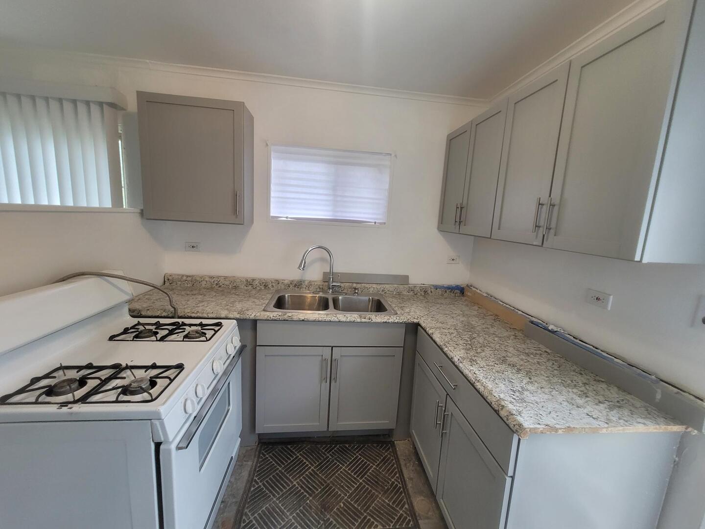 16523 Spaulding Avenue Markham, IL 60428 - Photo 9 of 15 a kitchen with a sink stove top oven and cabinets