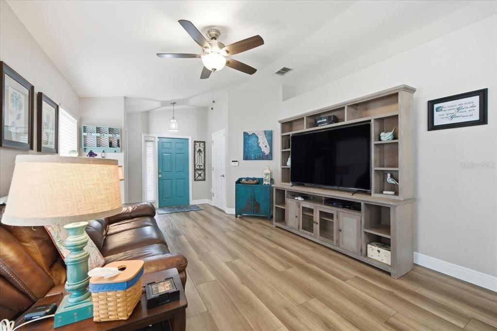 18641 Rolling Hills Loop Hudson, FL 34667 - Photo 11 of 44 a living room with furniture and a flat screen tv