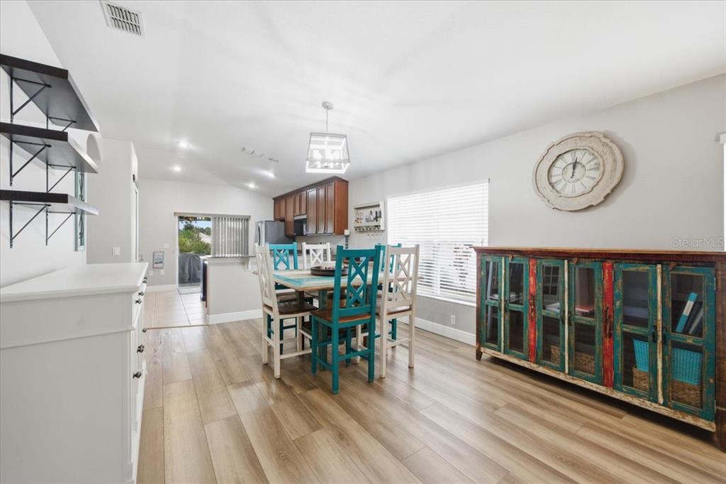 18641 Rolling Hills Loop Hudson, FL 34667 - Photo 12 of 44 a view of a dining room with furniture window and wooden floor
