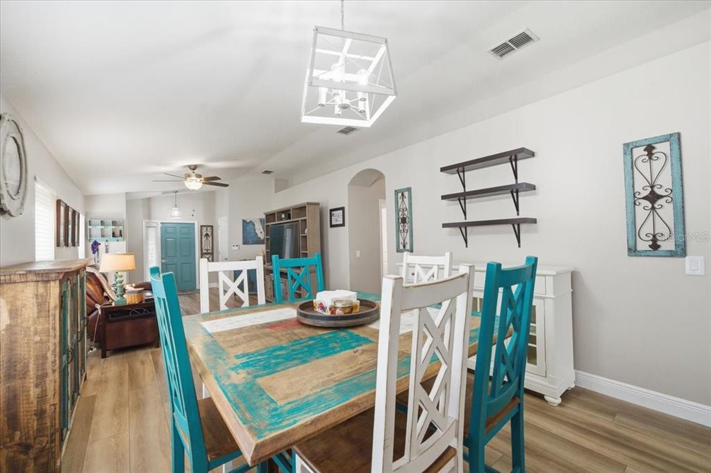 18641 Rolling Hills Loop Hudson, FL 34667 - Photo 14 of 44 a view of a dining room with furniture and wooden floor