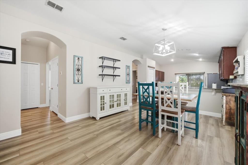 18641 Rolling Hills Loop Hudson, FL 34667 - Photo 15 of 44 a view of a dining room with furniture and wooden floor