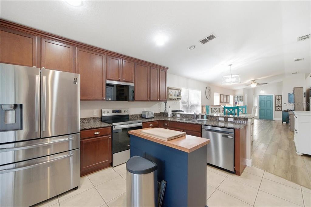 18641 Rolling Hills Loop Hudson, FL 34667 - Photo 22 of 44 a kitchen with granite countertop stainless steel appliances and wooden cabinets