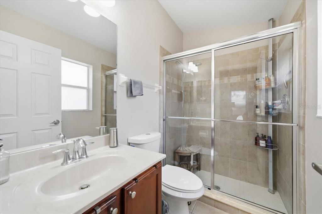 18641 Rolling Hills Loop Hudson, FL 34667 - Photo 26 of 44 a bathroom with a sink toilet and shower