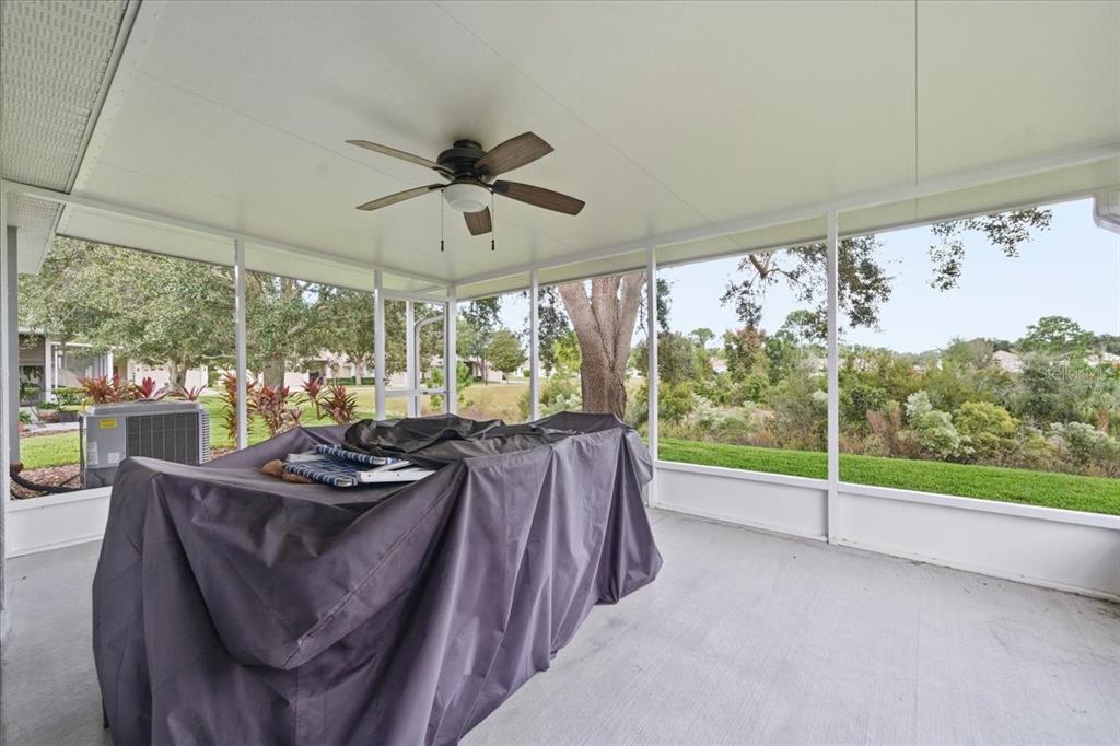 18641 Rolling Hills Loop Hudson, FL 34667 - Photo 32 of 44 a bed room with furniture and a floor to ceiling window