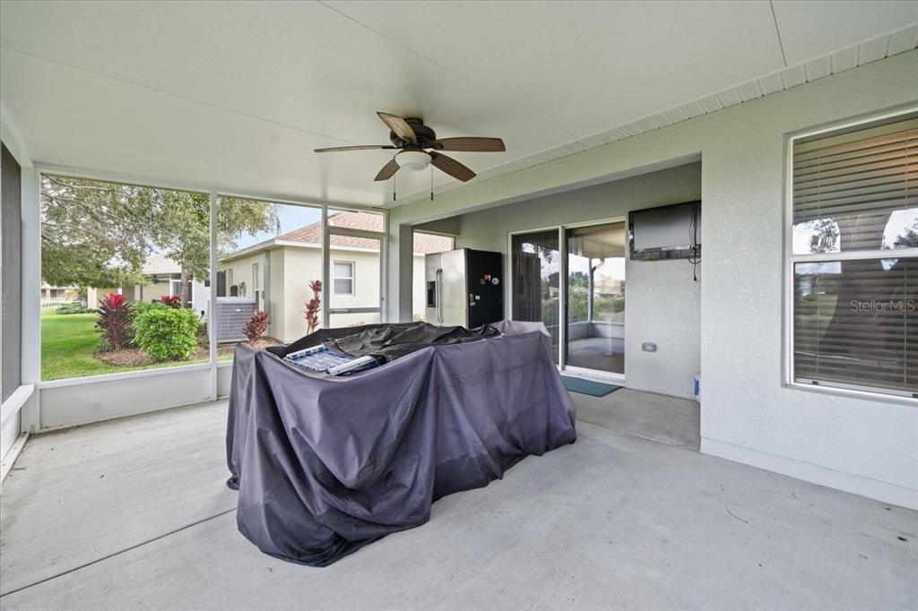 18641 Rolling Hills Loop Hudson, FL 34667 - Photo 34 of 44 a living room with furniture and a floor to ceiling window