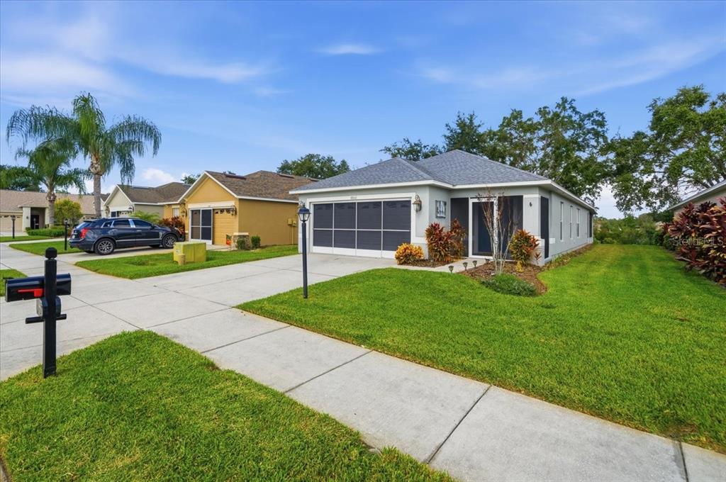 18641 Rolling Hills Loop Hudson, FL 34667 - Photo 4 of 44 a front view of a house with garden