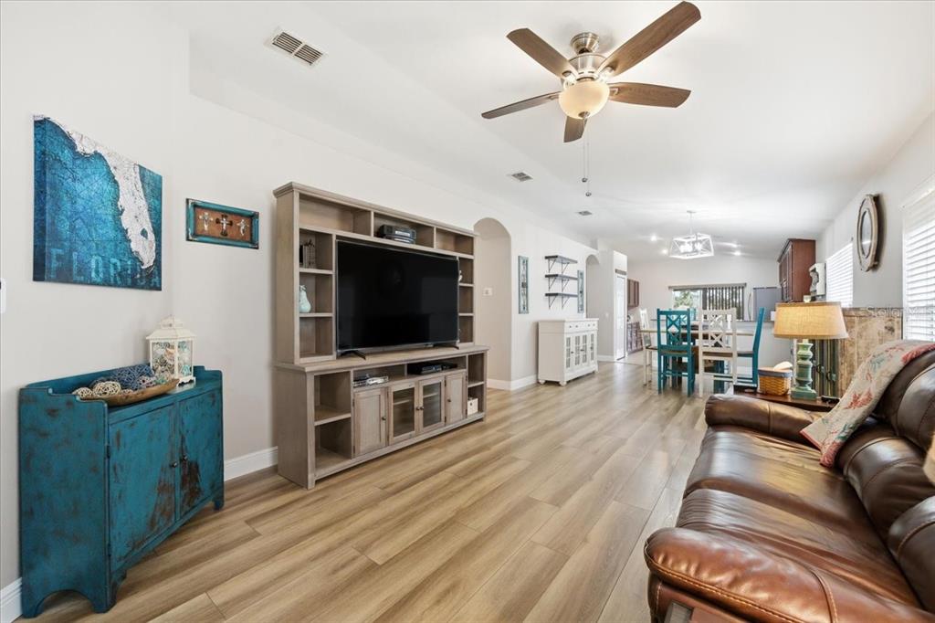 18641 Rolling Hills Loop Hudson, FL 34667 - Photo 8 of 44 a living room with furniture and a flat screen tv