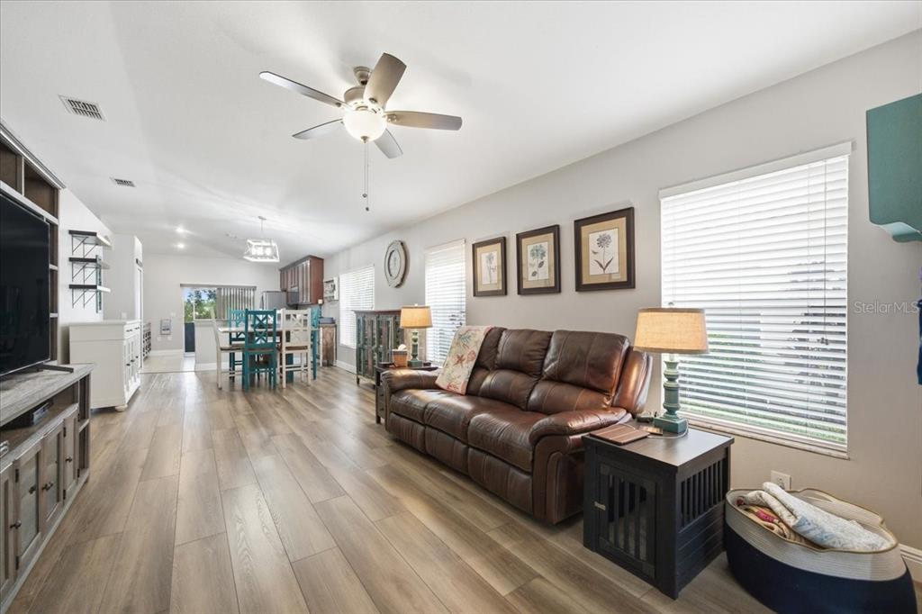 18641 Rolling Hills Loop Hudson, FL 34667 - Photo 9 of 44 a living room with furniture and a wooden floor