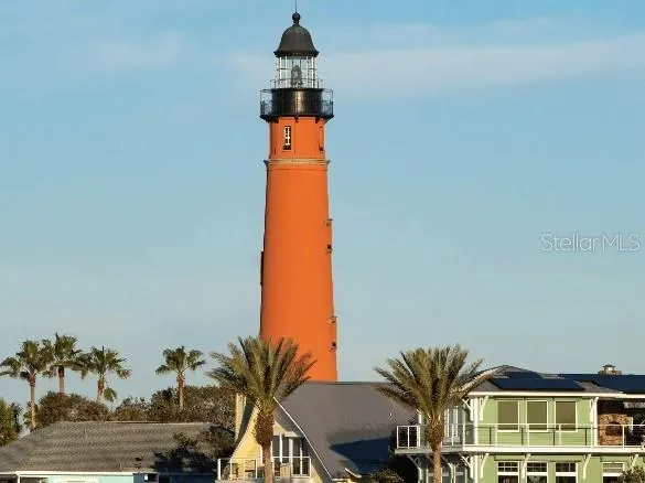 a front view of a house with outdoor space and seating area