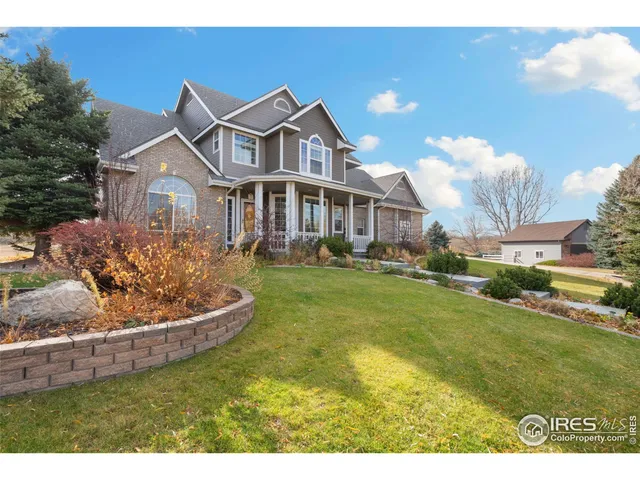 a front view of a house with a garden and plants