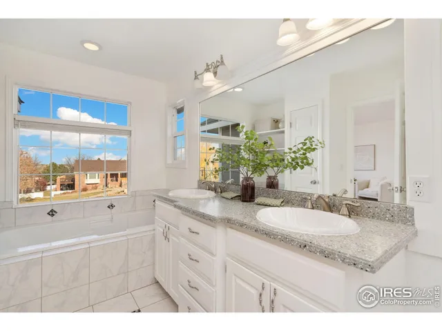 a bathroom with a granite countertop sink mirror and a