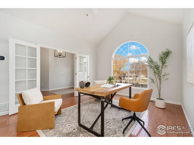 a view of a livingroom and a dining room with furniture window and outside view