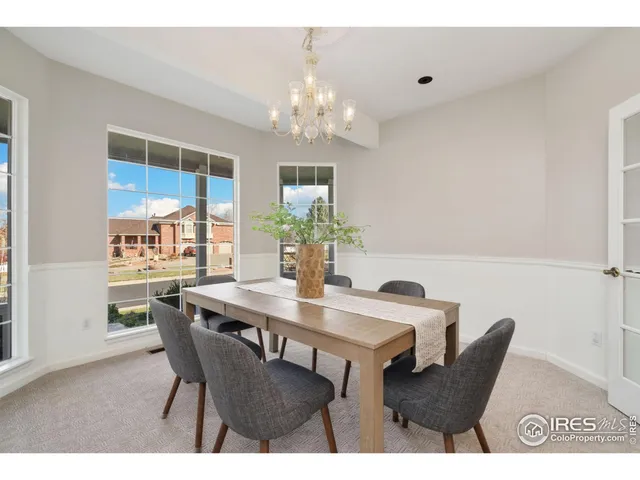 a view of a dining room with furniture and chandelier