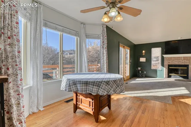 a living room with a table chairs and a chandelier