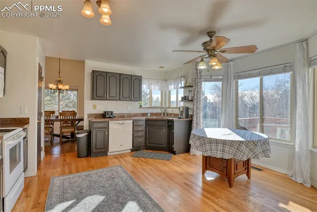 a kitchen with a table chairs refrigerator and cabinets