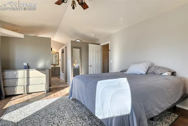 a spacious bedroom with a bed and a couch