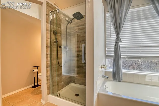 a bathroom with a shower and a bath tub