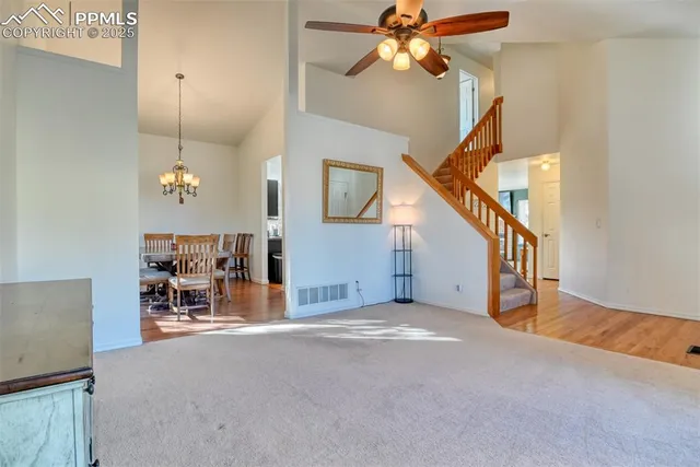 a view of livingroom with furniture and a chandelier fan