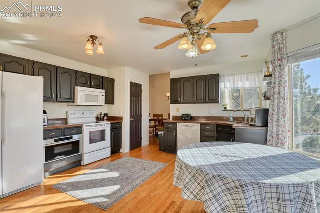 a kitchen with a refrigerator cabinets and wooden floor