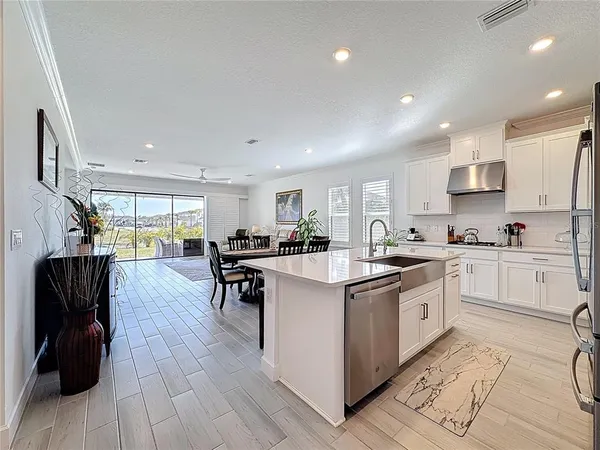 a kitchen with stainless steel appliances a sink a stove and cabinets