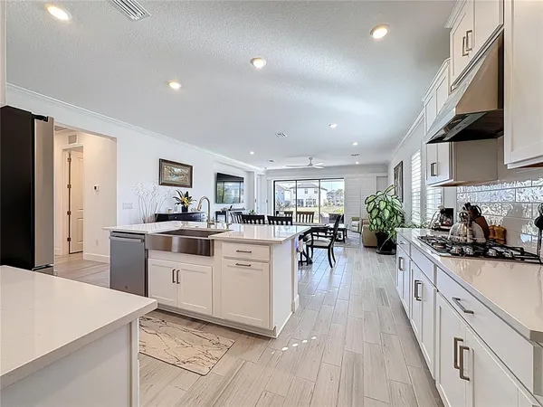 a kitchen with a refrigerator sink and cabinets