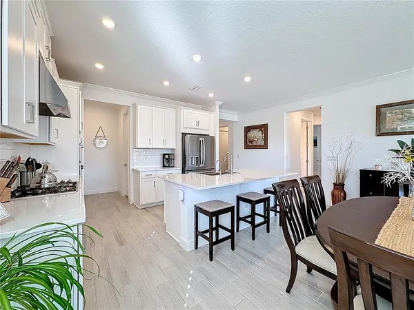 a kitchen with granite countertop white cabinets and white appliances