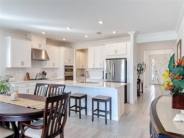 a kitchen with kitchen island granite countertop a sink and stainless steel appliances