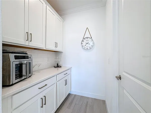 a living room with furniture large window and a potted plant