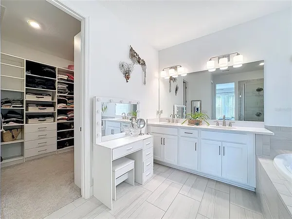 an aerial view of a house with a garden and lake view