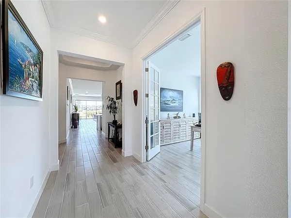 a kitchen with white cabinets and sink