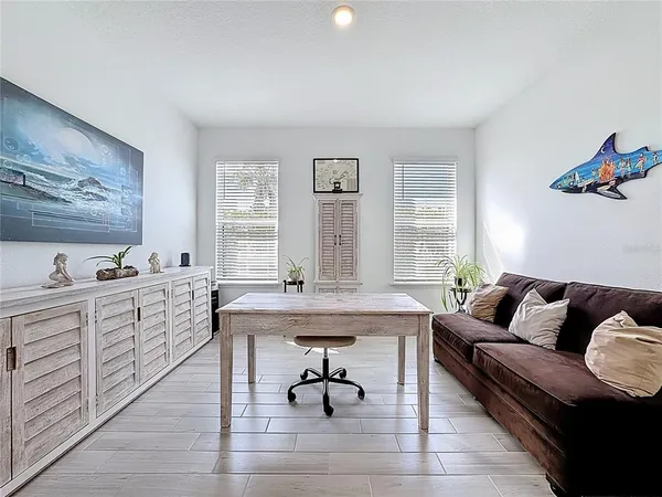 a kitchen with refrigerator and chairs