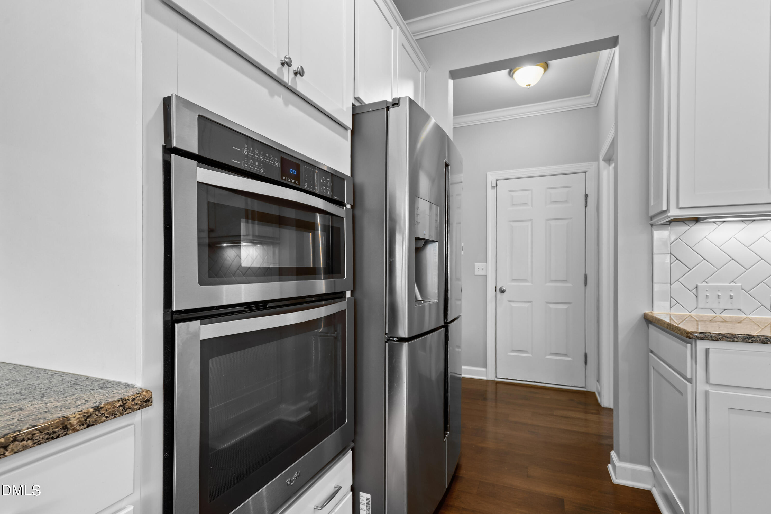 2039 Travern Drive Raleigh, NC 27603 - Photo 12 of 49 a kitchen with granite countertop cabinets stainless steel appliances and wooden floor