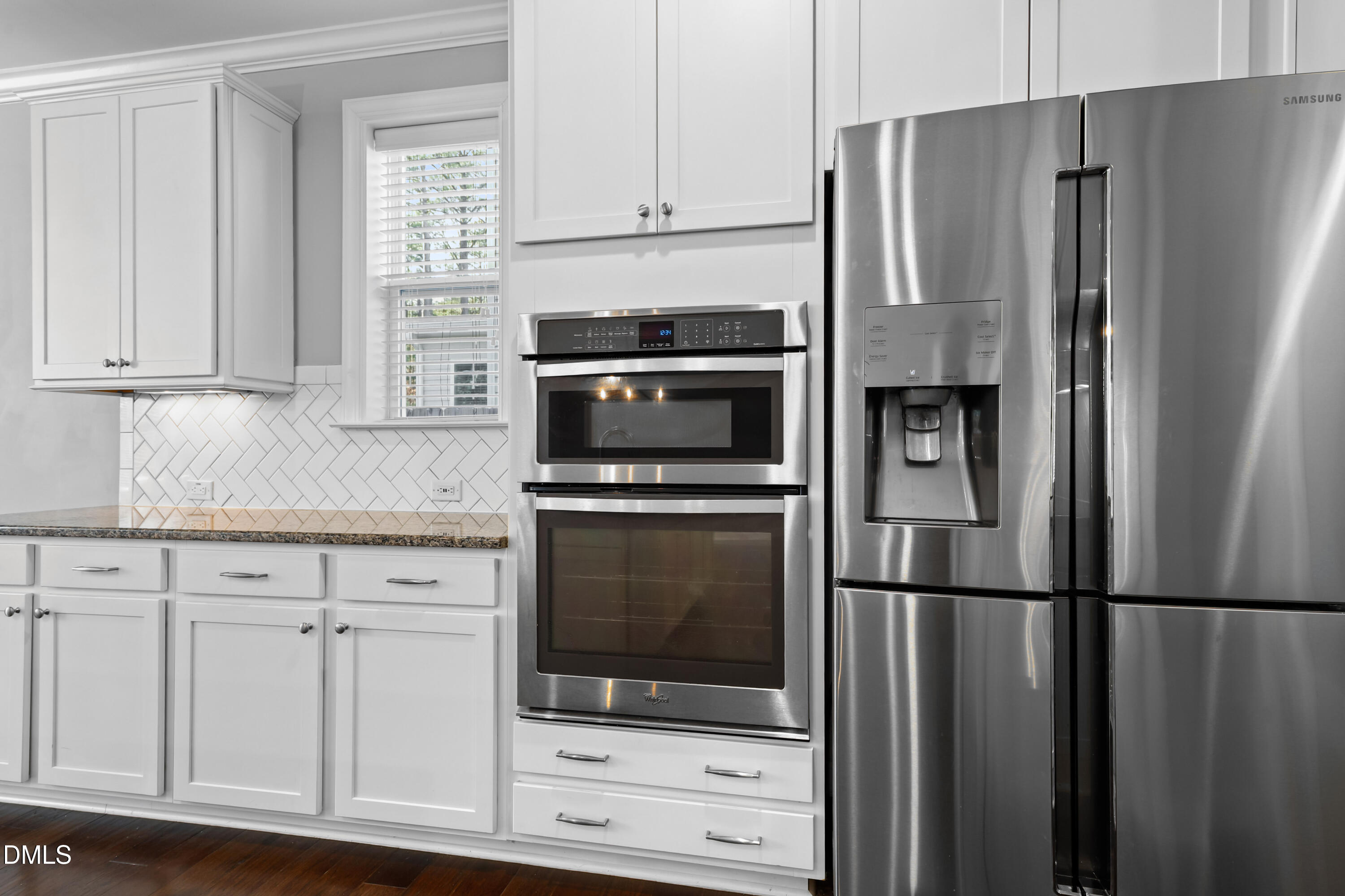 2039 Travern Drive Raleigh, NC 27603 - Photo 13 of 49 a kitchen with white cabinets and stainless steel appliances