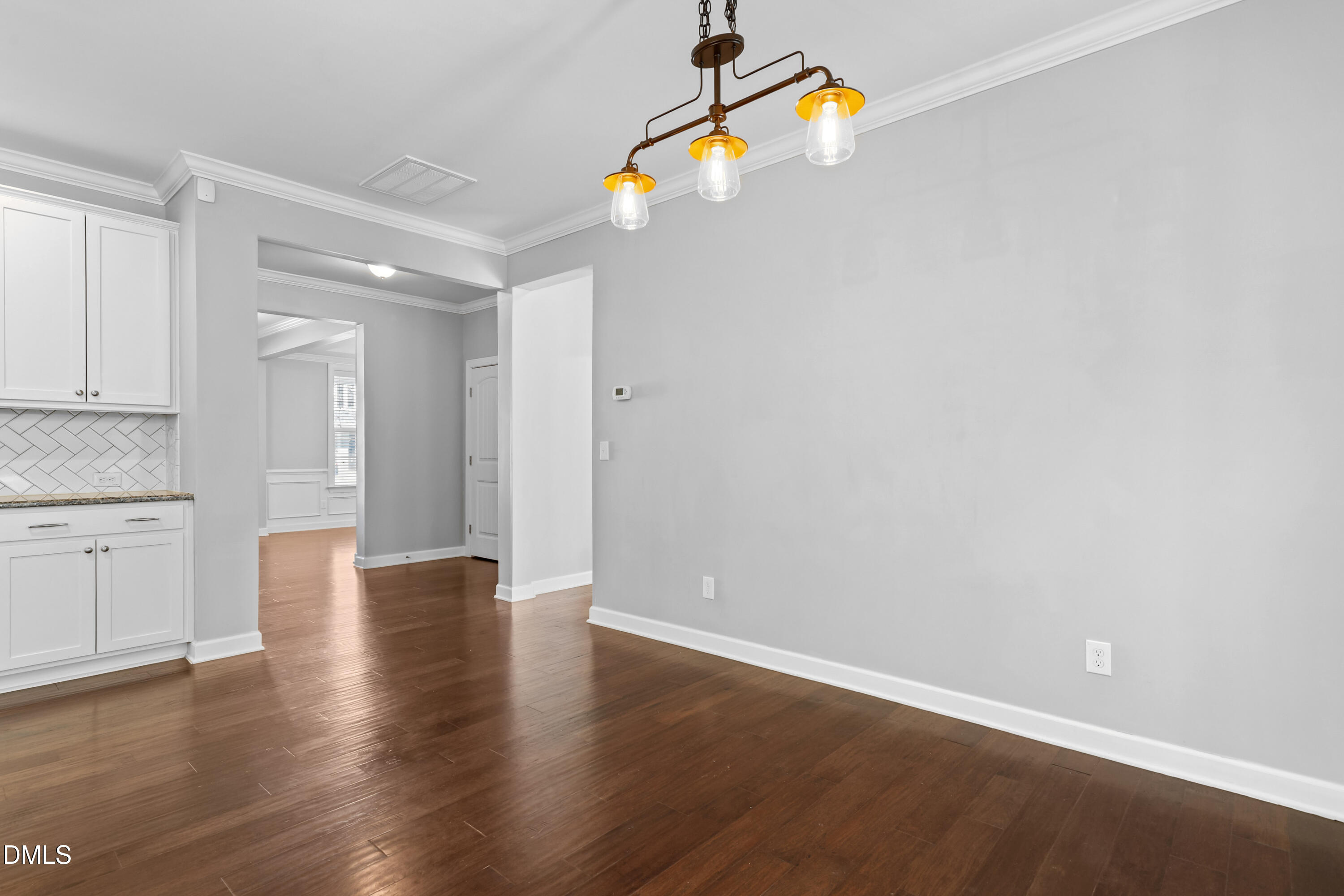 2039 Travern Drive Raleigh, NC 27603 - Photo 18 of 49 a view of an empty room with wooden floor and window