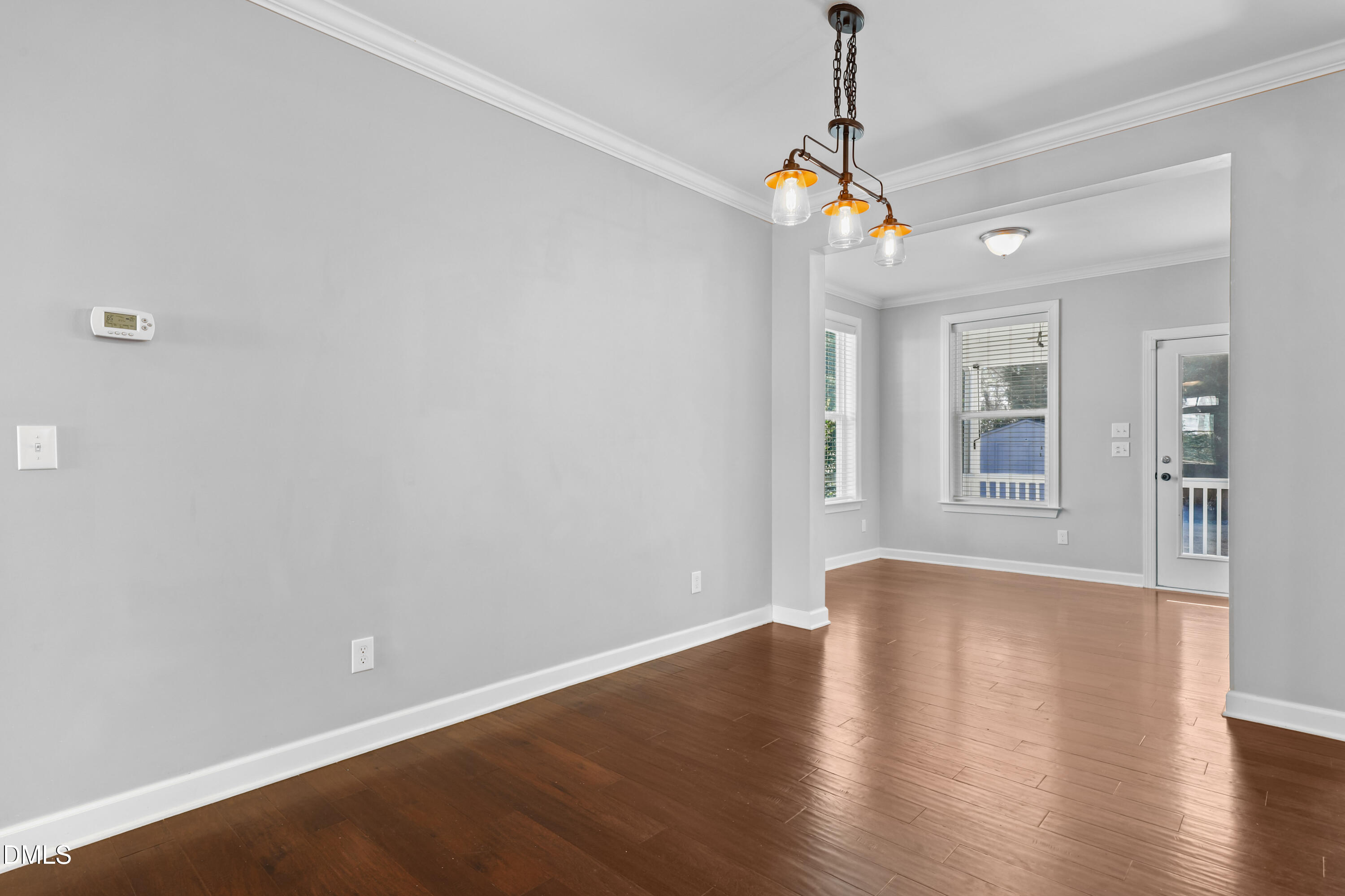 2039 Travern Drive Raleigh, NC 27603 - Photo 19 of 49 a view of an empty room with wooden floor and windows