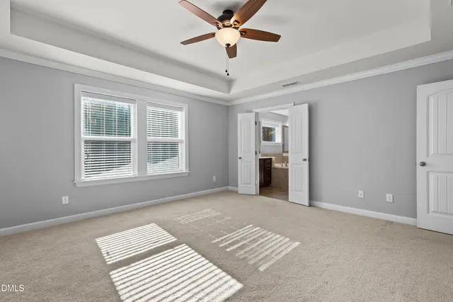 a view of a room with a ceiling fan and window