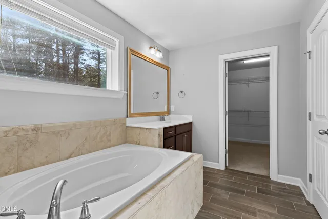 a bathroom with a tub and a window
